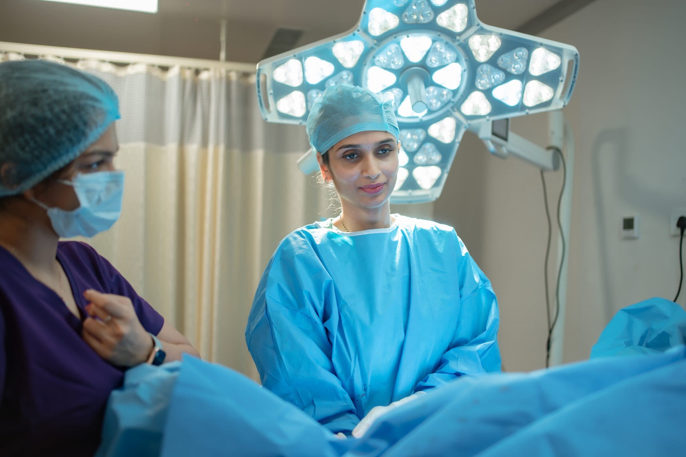 Two hands held together, a quiet moment of human connection during labour.