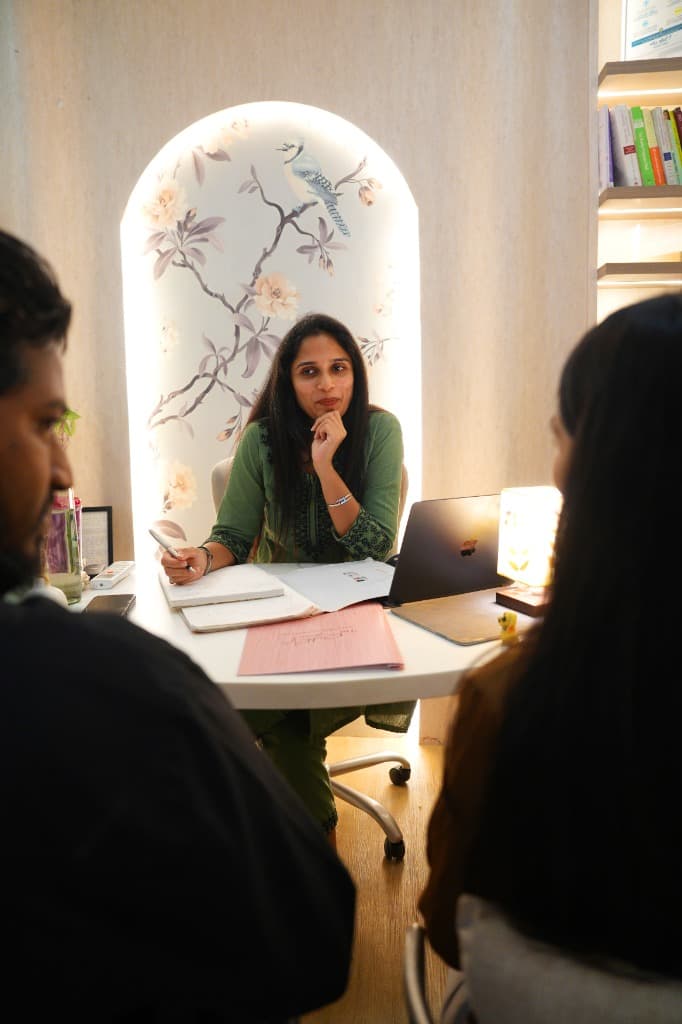 A couple discussing preconception care with their doctor during a consultation.
